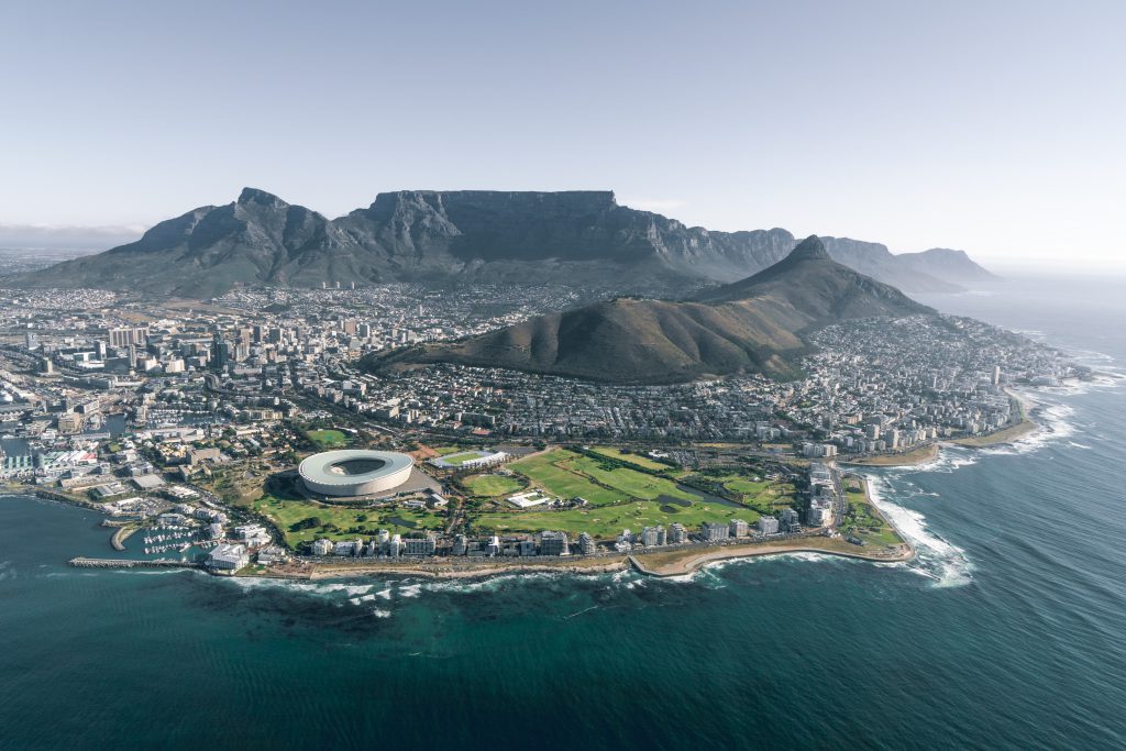 Bilden föreställer utsikt ovanifrån Stilla havet in över Kapstaden och Green Point Stadium och Table Mountain. Hos Liberal Praktik hittar du praktikplatser i Kapstaden.